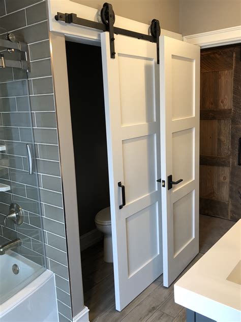 A Bathroom With Two Sliding Doors And A Toilet In The Corner Next To A