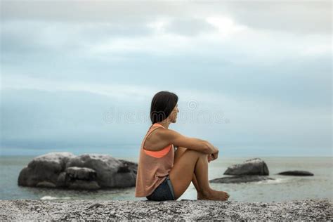 Woman Sitting On A Rock At Sunset On Bakovern Beach Cape Town Stock Photo Image Of Ocean
