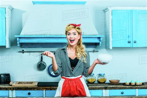 Beautiful Excited Pin Up Girl Cooking In Kitchen Stock Photo Dissolve