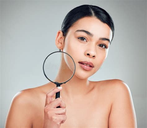 A Portrait Of A Beautiful Mixed Race Woman Posing With A Magnifying