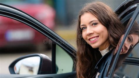 Young Woman Sits In A Car With An Open Door And Looks Back Close Up Portrait Stock Image