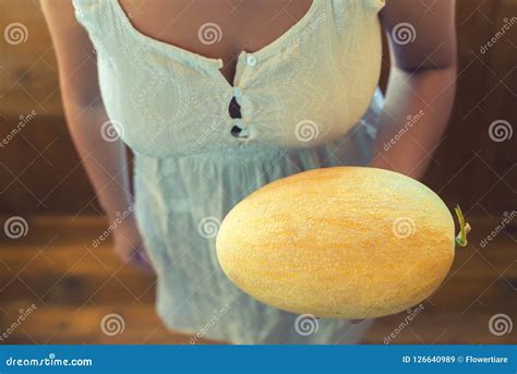 Young Peasant Girl With Big Melons In A Rustic White Dress On A Wooden Terrace Royalty Free