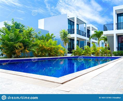 Low Angle View Of Swimming Pool And Resort With Blue Sky Background