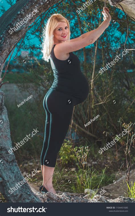 Cute Blonde Pregnant Women Posing Outdoors Stock Photo