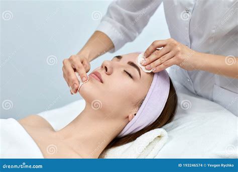 Doctor Beautician Cleanses The Skin Woman With A Sponge Stock Photo