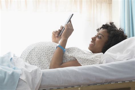 Pregnant African American Woman Using Digital Tablet In Hospital African American Women