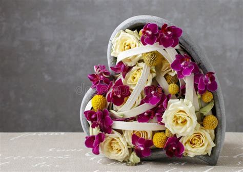Floral Arrangement With Roses And Orchids In Heart Shape Stock Photo