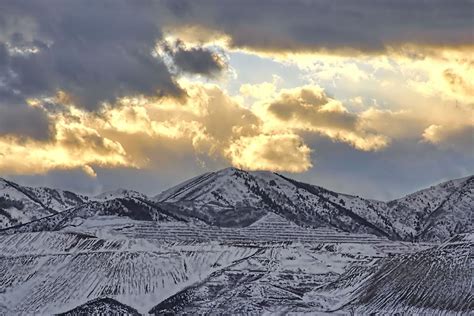 Stormy Sunset Over Snow Capped Mountains Photograph By Tracie Kaska