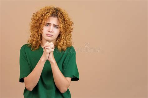 Woman With A Worried Face Praying With Her Hands Clasped Stock Image