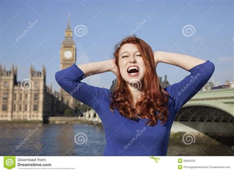 Angry Young Woman With Hands On Head Screaming Against Big Ben Clock