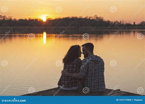 Couple Kissing At Lake Docks Enjoying The Sunset Stock Image Image Of Adventure Flirting