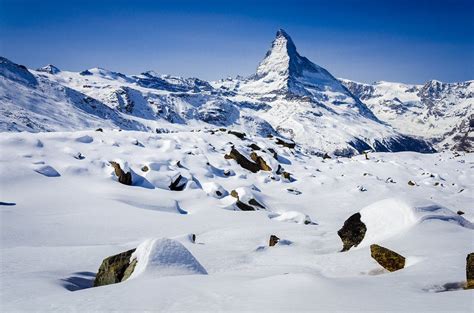 The Matterhorn Standing Tall Over A Snowy Field Of Boulders Above