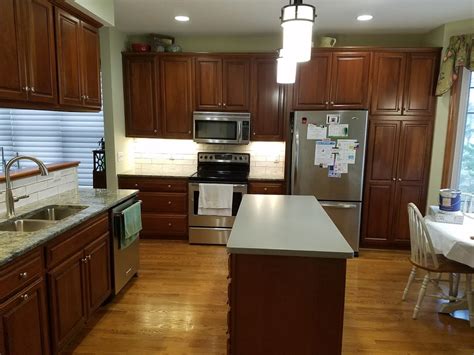 Kitchen With Cherry Cabinets And Green Accents Allrounder Remodeling Inc