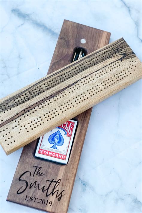 A Wooden Board With Some Playing Cards On It And A Bottle Opener In The