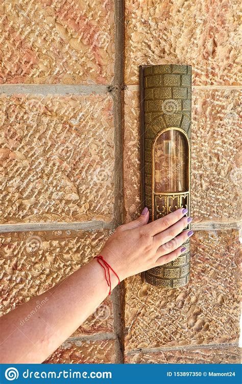 A Womanand X27s Hand With A Red Thread Touches The Mezuzah At The