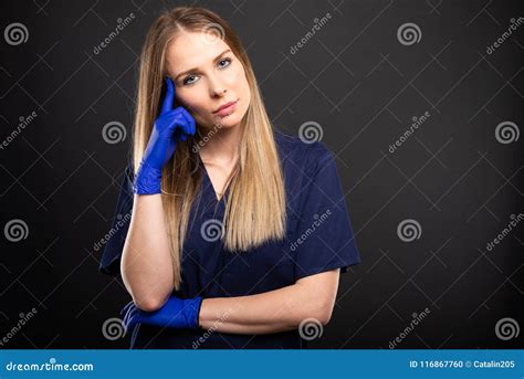 Beautiful Female Dentist Wearing Scrubs Posing With Like Thinking