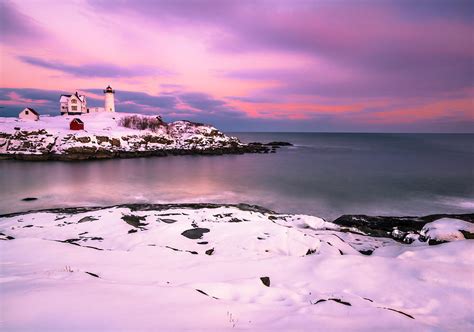 Sunset At Nubble Lighthouse In Maine In Winter Snow Photograph By
