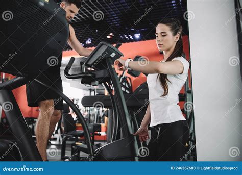 Attentive Trainer Looking At Fitness Tracker Stock Image Image Of