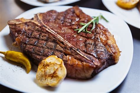 Medium Rare T Bone Steak Cooked On Grill Pan In American Restaurant