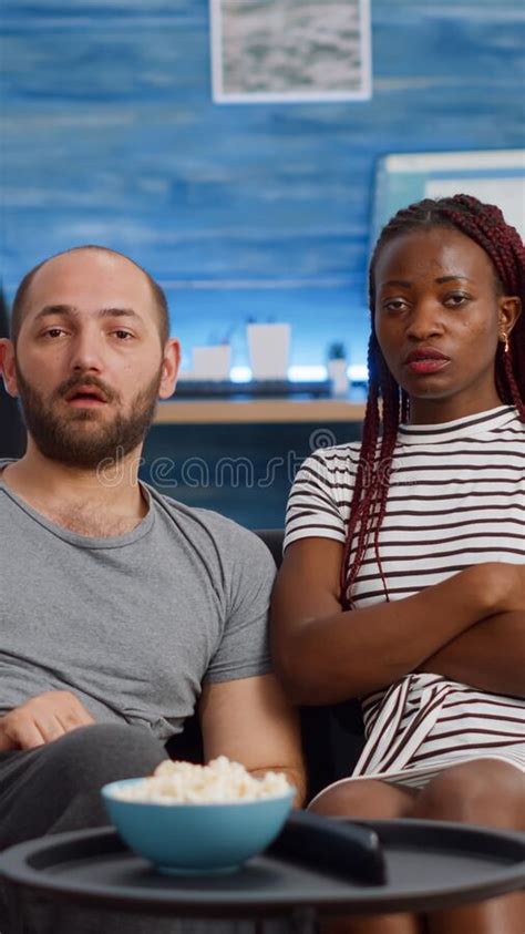 Pov Of Interracial Couple Being Shocked Watching Television Stock Image