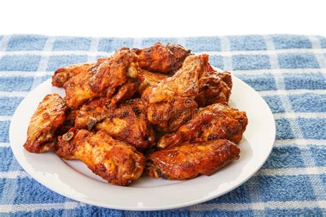 White Plate Of Chicken Wings On Blue Mat Stock Photo Image Of Backed