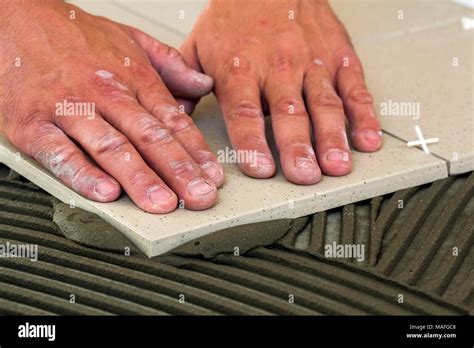 Ceramic Tiles And Tools For Tiler Worker Hand Installing Floor Tiles