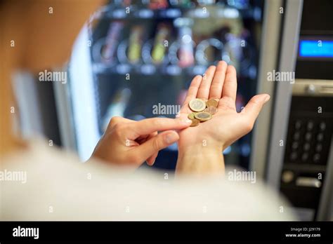 Woman Counting Euro Coins At Vending Machine Stock Photo Alamy