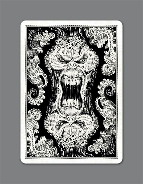 A Black And White Playing Card With An Image Of A Demon Face On The Front