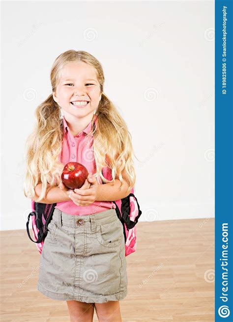 Education Girl Bringing Apple To School For Teacher Stock Photo
