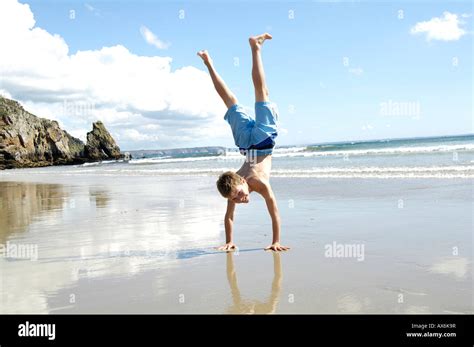 Boy Doing Handstand At Beach Stock Photo Alamy