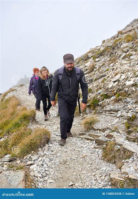 People With Backpacks Hiking Into The Mountains Stock Photo Image Of