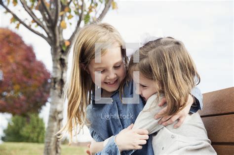 Sisters Hugging Outdoors — Photo — Lightstock