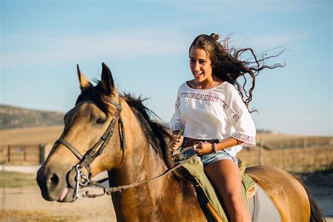 Cheerful Teen Riding Horse By Stocksy Contributor Victor Torres
