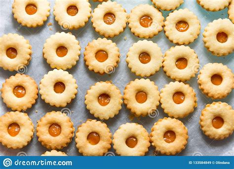 Here are some austrian linzer cookies with a red preserve filling that seem perfectly suited for the place the top layer cookie over the bottom, pressing down lightly. Traditional Austrian home baked Christmas cookies Linzer eyes with apricot jam #christmas # ...