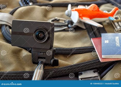 conceptual picture of tourism camera action selfie stick planning trip with map passport