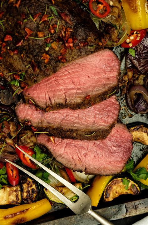 Sliced Grilled Beef Rump Steak On Baking Tray With Vegetables Stock