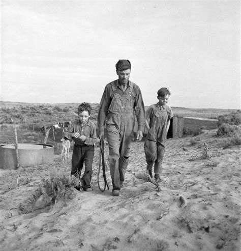 An Old Black And White Photo Of Three Men Walking In The Desert