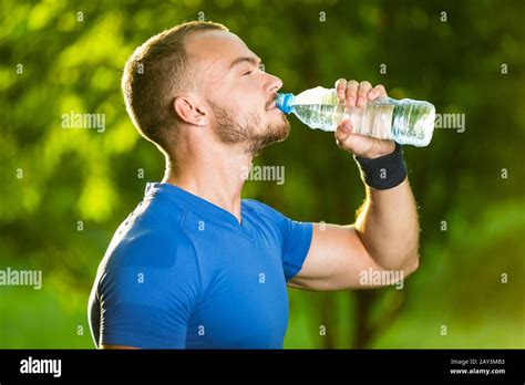 Athletic Mature Man Drinking Water From A Bottle Stock Photo Alamy