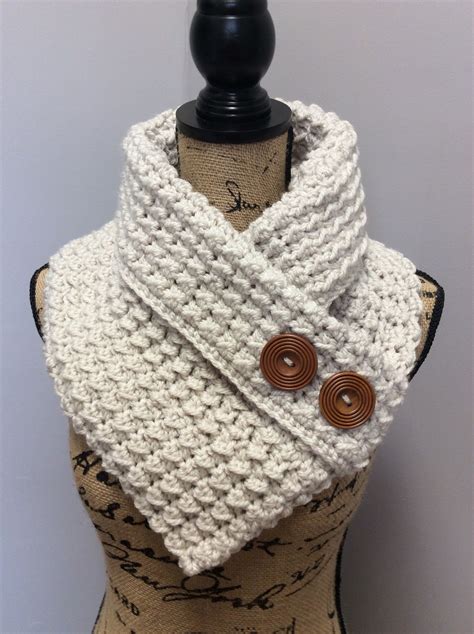 A White Knitted Cowl With Buttons On It