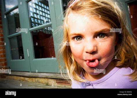 Little Girl Sticking Out Her Tongue Making A Funny Face Stock Photo Alamy