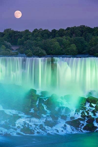 Purple Night Sky With Full Moon Over Emerald Green And Blue Waterfall