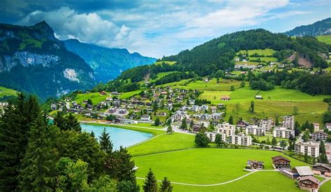 Houses Lake Town Alps Forest Buildings Switzerland Mountains Grass