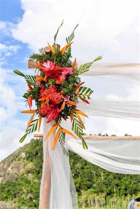 A Wedding Arch Decorated With Flowers And Greenery