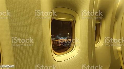 Airport Window Inside Airplane Above The Night Sky Stock Photo