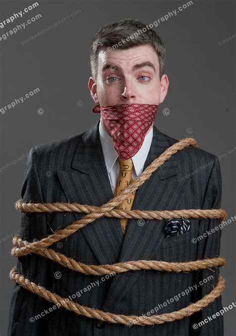 Well Dressed Man In A Suit Tied Up And Gagged With A Handkerchief