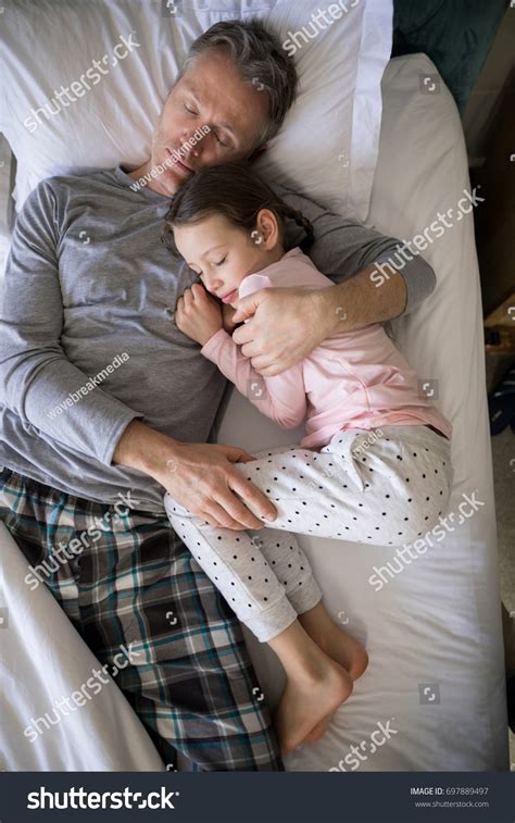 Father Daughter Sleeping Together On Bed Stock Photo 697889497