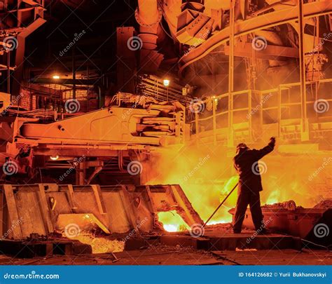 Steelworker Near A Blast Furnace With Sparks Foundry Heavy Industry