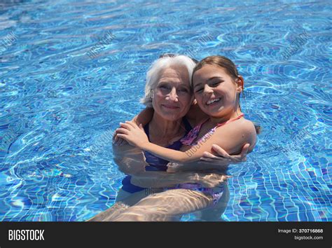 Grandmother In The Pool With Her Granddaughter High Res Stock Photo