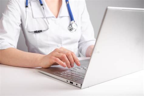 Doctor Dr Working At Laptop Using Computer At Workspace Stock Photo