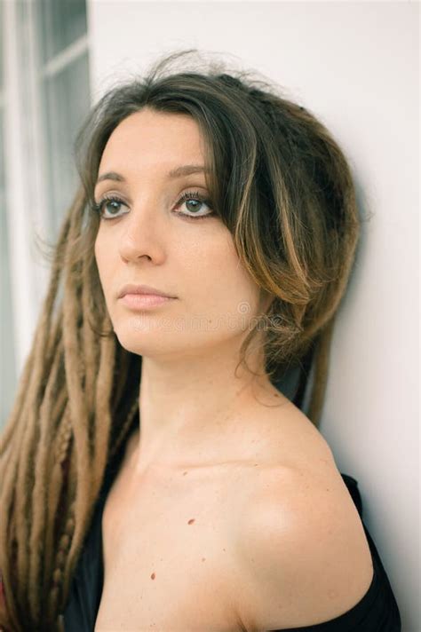 Indoors Female Portrait Of A Woman With Dreadlocks Hairstyle And Smoky